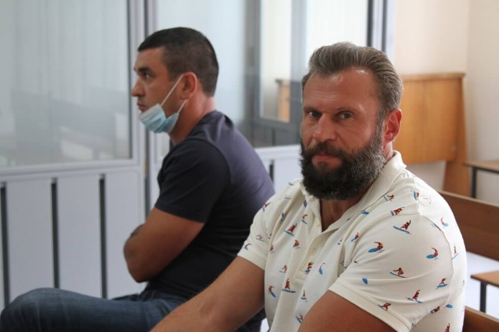Обвинувачені Євген Сміцький та Віталій Блинник (позаду) у Київському райсуді Полтави, 21 липня 2021 року. Фото: Ганна Соколова, Ґрати